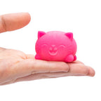 A pink Teenie NeeDoh Cool Cats squishy held in a hand