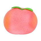 Peach Squishy, a soft pink peach squeeze toy with green leaves
