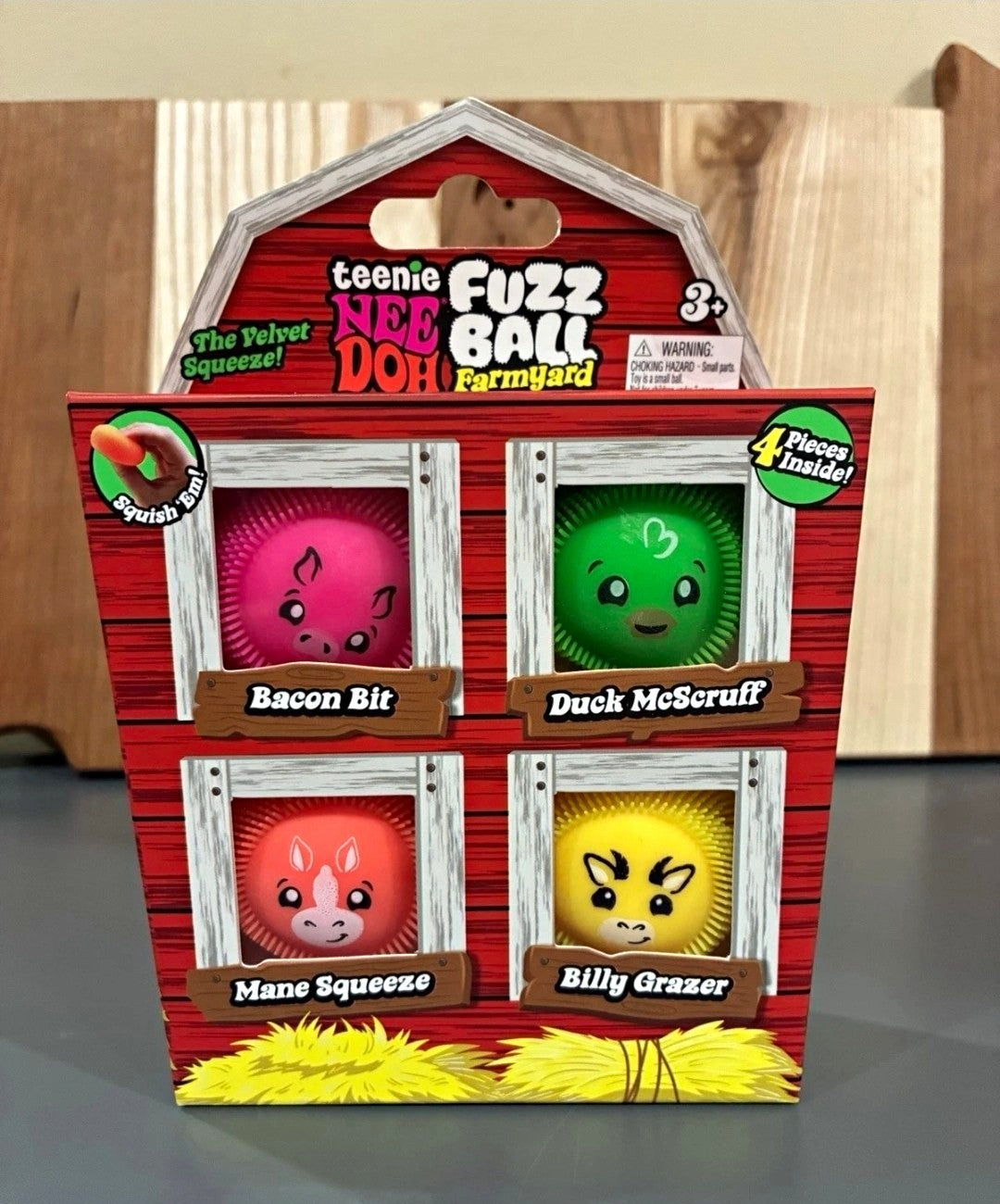 Teenie NeeDoh Farmyard Fuzz Balls 4-pack in its barn-shaped box